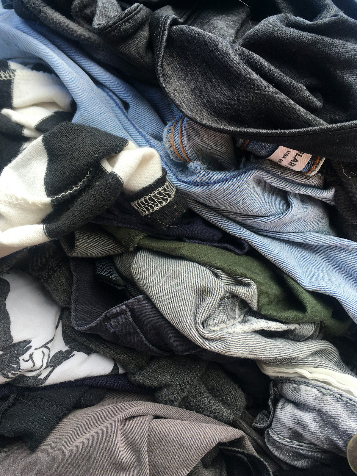 Pile of vintage denim and shirts