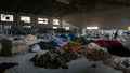 Bulk clothing being sorted in a warehouse