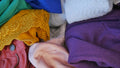Pile of colourful pre-owned clothing