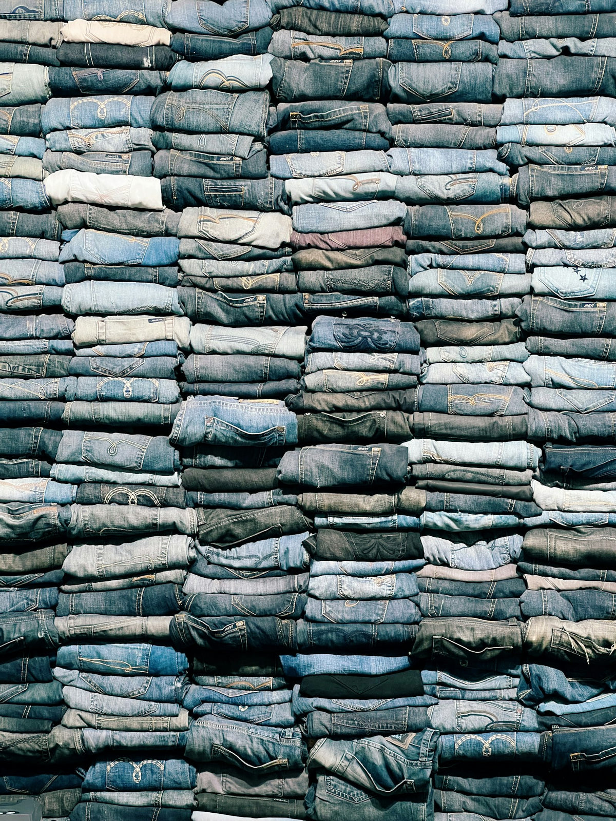 Stacked pile of trousers and jeans